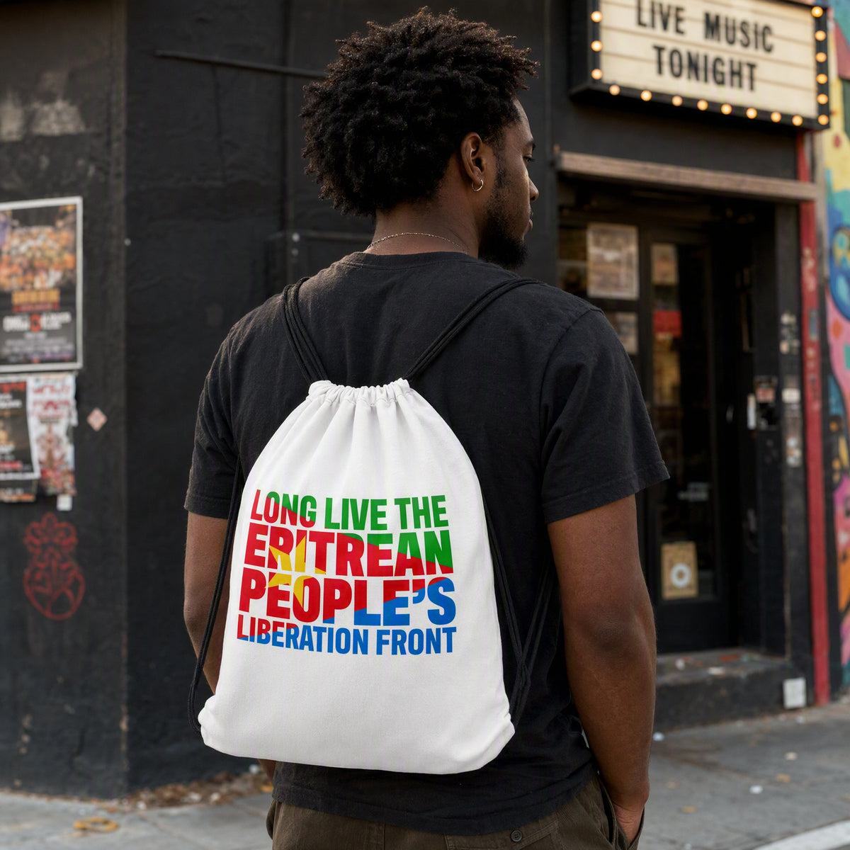 Man wearing the white Eritrean People’s Liberation Front drawstring bag outside a music venue.